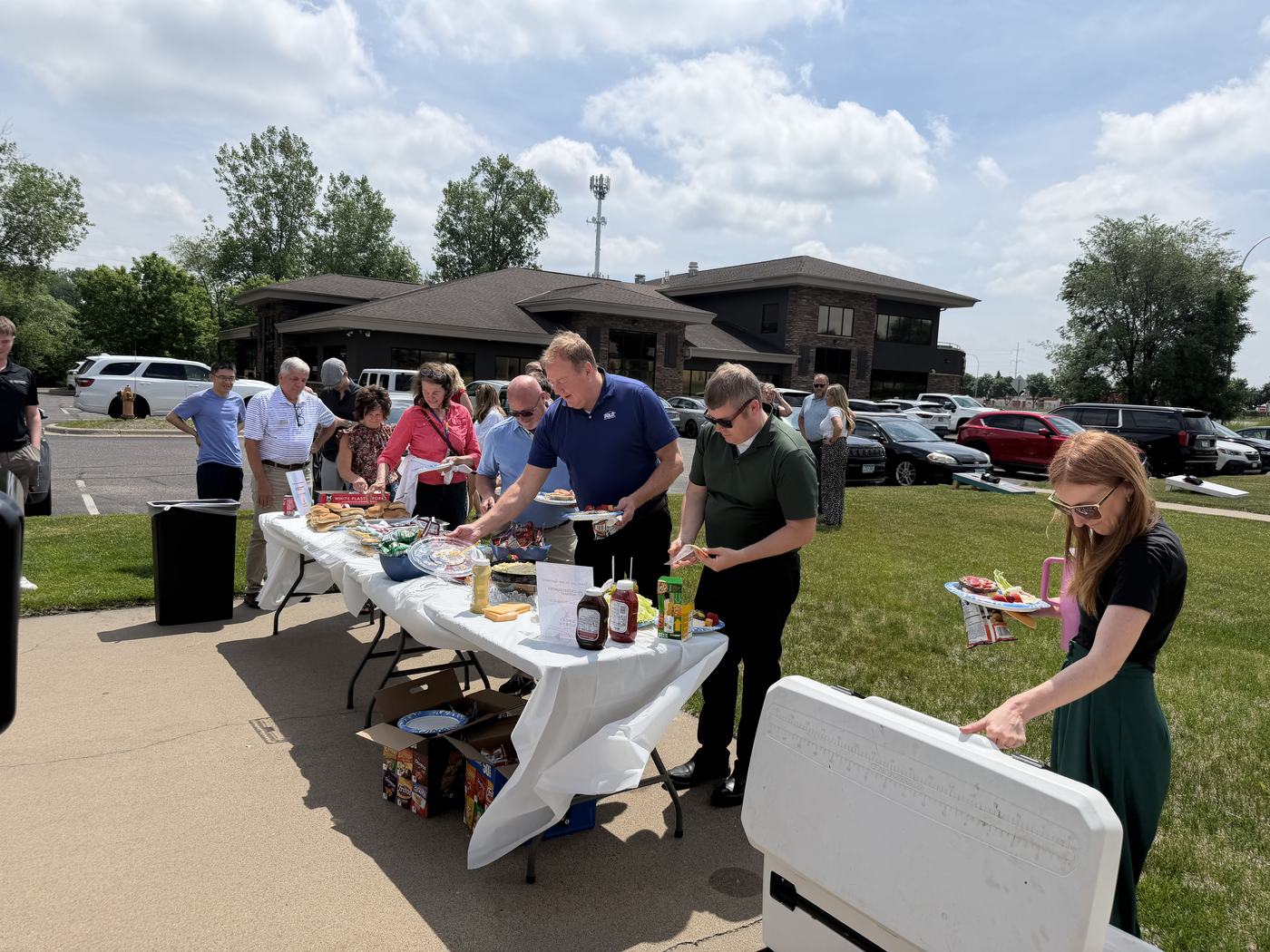 Agents gathered outside the Coon Rapids office for the market center 23rd anniversary cookout