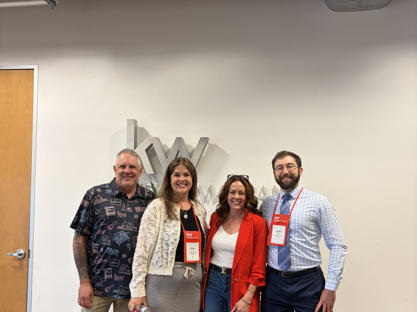 KWCR agents at a Keller Williams event in front of the KW wall logo