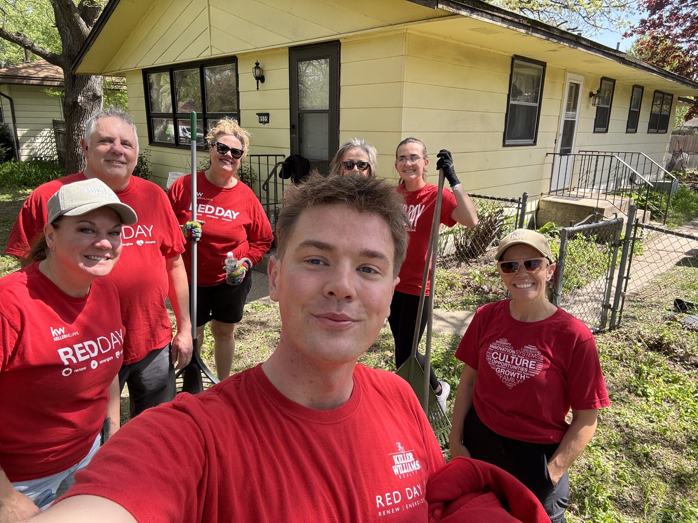 KWCR agents in RED Day shirts outside a north metro home they spent the day working on
